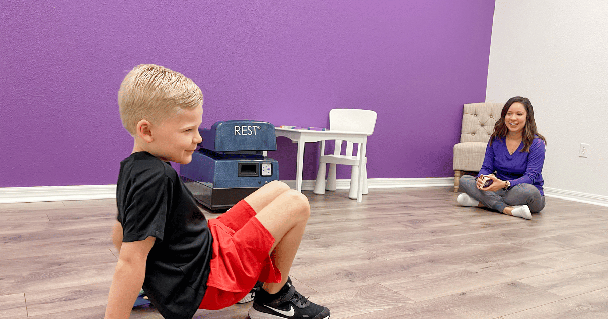 speechtherapy Child on floor participating in pediatric speech therapy